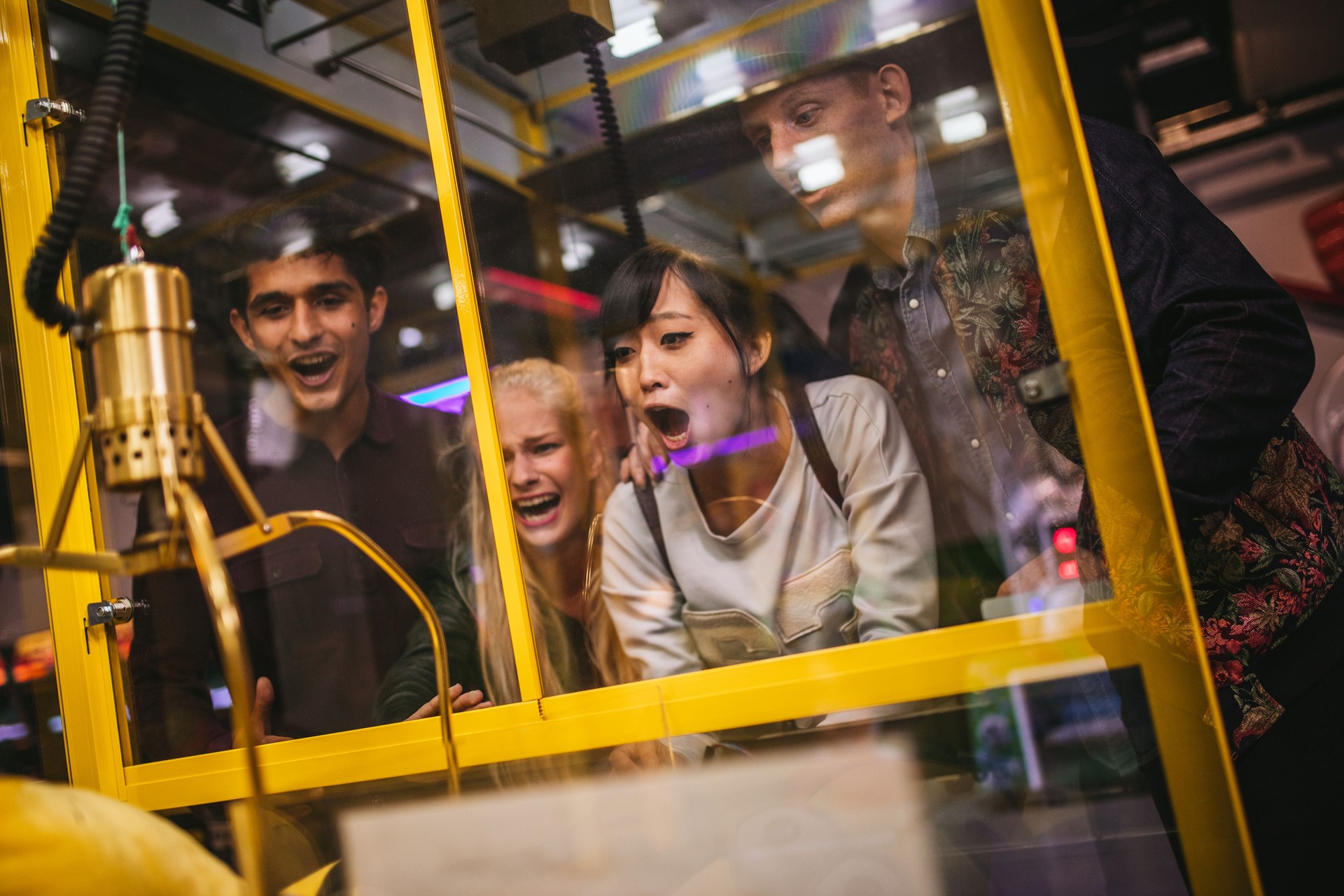 Excited young friends playing toy grabbing game